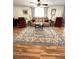 Comfortable living room featuring a plush sofa, recliner chairs, and a decorative rug on wood-look flooring at 199 Palm Harbor Dr, North Port, FL 34287