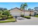 Charming home featuring a tile roof, manicured landscaping, and a spacious three-car garage at 20390 Cavallo Ct, Venice, FL 34292