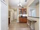 Hallway area with a display cabinet, decorative table, and access to other rooms in the home at 20390 Cavallo Ct, Venice, FL 34292