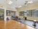 Weight room with dumbbells, benches and television for staying motivated during workouts at 20390 Cavallo Ct, Venice, FL 34292