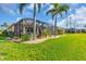 An inviting screened-in lanai and lush landscaping enhance this home's outdoor charm at 2172 Chenille Ct, Venice, FL 34292
