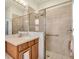 Bathroom featuring a tiled shower with glass doors and a sink with vanity at 2172 Chenille Ct, Venice, FL 34292