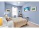 A bright bedroom with neutral carpet, TV, and a large window at 2172 Chenille Ct, Venice, FL 34292