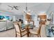 The dining area features a glass table, with kitchen and living areas visible in the open floor plan at 2172 Chenille Ct, Venice, FL 34292