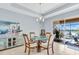 Charming dining room with tile floors, recessed lighting, and views of the waterfront patio and beyond at 2172 Chenille Ct, Venice, FL 34292