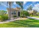 Charming home with mature tropical landscaping and a brick paver walkway leading to the entrance at 2172 Chenille Ct, Venice, FL 34292