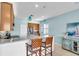 Bright kitchen features a breakfast bar, pendant lights, and stainless steel appliances at 2172 Chenille Ct, Venice, FL 34292