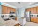 The kitchen offers stainless steel appliances, wooden cabinetry and light stone countertops at 2172 Chenille Ct, Venice, FL 34292