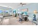 Open-concept living area with multiple workspaces, comfortable seating, and bright natural light at 2172 Chenille Ct, Venice, FL 34292