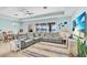 Comfortable living room featuring a large sectional sofa, ceiling fan and view to the lanai at 2172 Chenille Ct, Venice, FL 34292