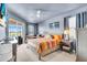 Main bedroom with a ceiling fan, balcony access and large window at 2172 Chenille Ct, Venice, FL 34292