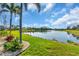 A picturesque view of a pond and surrounding green space, offering a tranquil setting at 2172 Chenille Ct, Venice, FL 34292