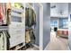 Well-organized closet with custom shelving and drawers leading into a bedroom with pool views at 2172 Chenille Ct, Venice, FL 34292