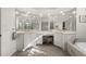 Bright bathroom featuring dual sinks, ample mirrors, garden tub and natural light at 2175 Calusa Lakes Blvd, Nokomis, FL 34275