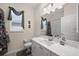 Well-lit bathroom with a single vanity, granite countertops, and decorative window treatments at 2175 Calusa Lakes Blvd, Nokomis, FL 34275