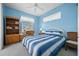 Bright and airy bedroom with a blue and white striped bed and charming decor at 2175 Calusa Lakes Blvd, Nokomis, FL 34275