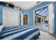 Bedroom with blue accents, closet, and sliding glass doors leading to the pool area at 2175 Calusa Lakes Blvd, Nokomis, FL 34275