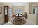 Dining room with a round table, chandelier, and window overlooking the backyard at 2175 Calusa Lakes Blvd, Nokomis, FL 34275