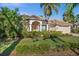 Inviting home exterior featuring manicured landscaping, a paver driveway, and a well-kept lawn at 2175 Calusa Lakes Blvd, Nokomis, FL 34275
