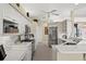 Modern kitchen with stainless steel appliances, ample white cabinetry, and stylish subway tile backsplash at 2175 Calusa Lakes Blvd, Nokomis, FL 34275