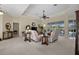 Spacious living room with neutral tones, ceiling fan, and sliding glass doors to the outside at 2175 Calusa Lakes Blvd, Nokomis, FL 34275