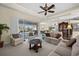 Large living room with view of the screened-in lanai, comfortable furniture, and open layout at 2175 Calusa Lakes Blvd, Nokomis, FL 34275