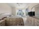 Cozy bedroom with bay windows offering a view of the pool, and a large dresser at 2175 Calusa Lakes Blvd, Nokomis, FL 34275