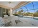Screened lanai with ceiling fan, pool access, and a lovely backyard view at 2175 Calusa Lakes Blvd, Nokomis, FL 34275