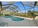 Screened-in pool with views of the golf course and lush landscaping at 2175 Calusa Lakes Blvd, Nokomis, FL 34275