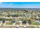Panoramic aerial view of a residential community interspersed with green spaces and golf courses at 221 Mark Twain Ln, Rotonda West, FL 33947