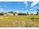 Expansive backyard featuring mature landscaping and a screened-in pool enclosure at 221 Mark Twain Ln, Rotonda West, FL 33947