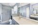 Bathroom featuring light blue accents, single vanity, walk-in shower, and ample lighting at 221 Mark Twain Ln, Rotonda West, FL 33947