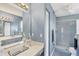 Bright bathroom with dual vanities, a walk-in shower, and ample cabinet space at 221 Mark Twain Ln, Rotonda West, FL 33947