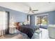 Cozy bedroom featuring blue walls, tile floor, and access to a screened-in pool area at 221 Mark Twain Ln, Rotonda West, FL 33947