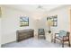 Spare bedroom featuring blue accent chairs and a vintage dresser at 221 Mark Twain Ln, Rotonda West, FL 33947