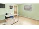 Bright bedroom featuring green walls, laminate wood flooring, desk, and a window at 221 Mark Twain Ln, Rotonda West, FL 33947