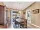 Charming dining area featuring a stylish chandelier, access to the pool area, and inviting ambiance at 221 Mark Twain Ln, Rotonda West, FL 33947