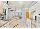 Bright kitchen with white cabinetry, tile floors, and a view to the backyard at 221 Mark Twain Ln, Rotonda West, FL 33947