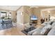 Cozy living room offering an open floor plan, wood floors, and ample natural light at 221 Mark Twain Ln, Rotonda West, FL 33947