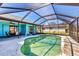 Backyard pool featuring a screened-in lanai and adjacent patio at 221 Mark Twain Ln, Rotonda West, FL 33947