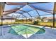 A screened-in pool with a sunny blue sky above at 221 Mark Twain Ln, Rotonda West, FL 33947
