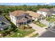 Aerial view showcasing the home's tile roof, neutral paint, two-car garage and landscaped front yard at 228 Caserta Ct, North Venice, FL 34275