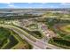 Expansive aerial view of a Primary-planned community with lush landscaping, ponds, and diverse housing options at 228 Caserta Ct, North Venice, FL 34275
