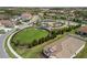 Aerial view of the neighborhood park, walking trail, and surrounding houses in the community at 228 Caserta Ct, North Venice, FL 34275
