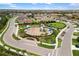 Aerial view of the neighborhood park, playground, surrounding houses, and community at 228 Caserta Ct, North Venice, FL 34275