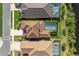 An aerial shot displaying well-maintained homes with screened-in pools, set against a backdrop of lush greenery at 228 Caserta Ct, North Venice, FL 34275