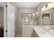 Bathroom with gray tiled shower, vanity, and enclosed toilet at 228 Caserta Ct, North Venice, FL 34275