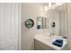 Clean bathroom vanity with modern sink, decor and large mirror above the counter at 228 Caserta Ct, Nokomis, FL 34275