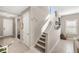 Inviting entryway with tiled floors, white door, and staircase leading to the second level at 228 Caserta Ct, North Venice, FL 34275