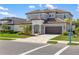 Charming two-story home with a well-manicured lawn, neutral paint, brown garage door and tile roof at 228 Caserta Ct, North Venice, FL 34275